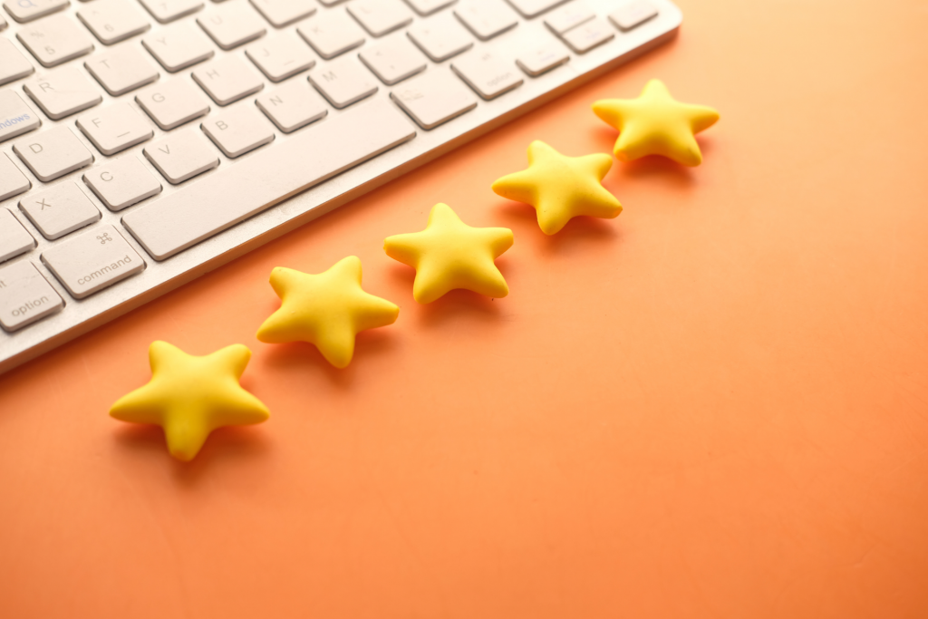 five stars next to a keyboard on an orange background